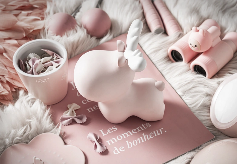 一个带有粉红色Hello Kitty床单和粉红色杯子的床。