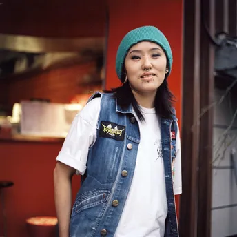 一位穿着工作服和绿色贝雷帽的年轻女子