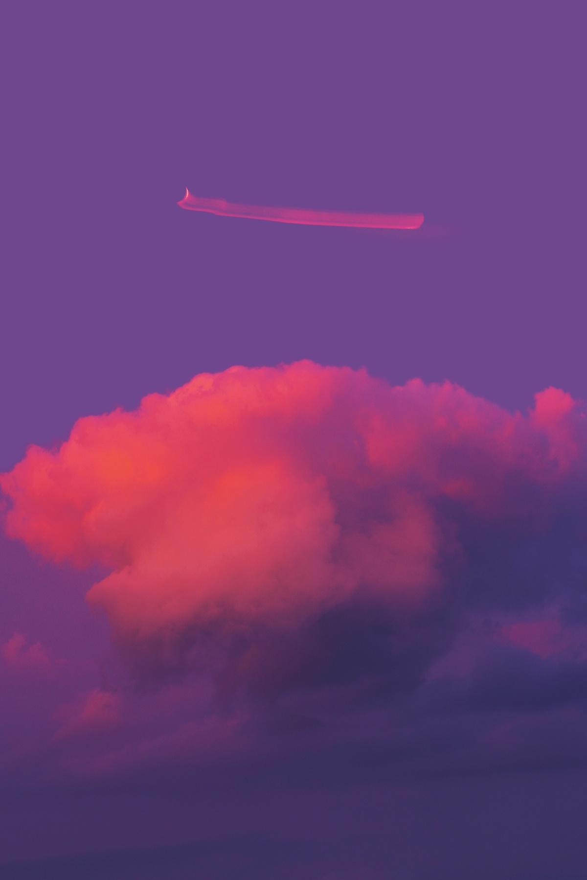 一架红色飞机在紫色的天空中飞行