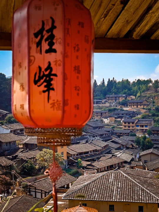 一盏红灯笼悬挂在小镇的屋顶上