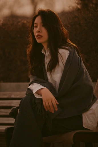 一个年轻女子坐在木凳上