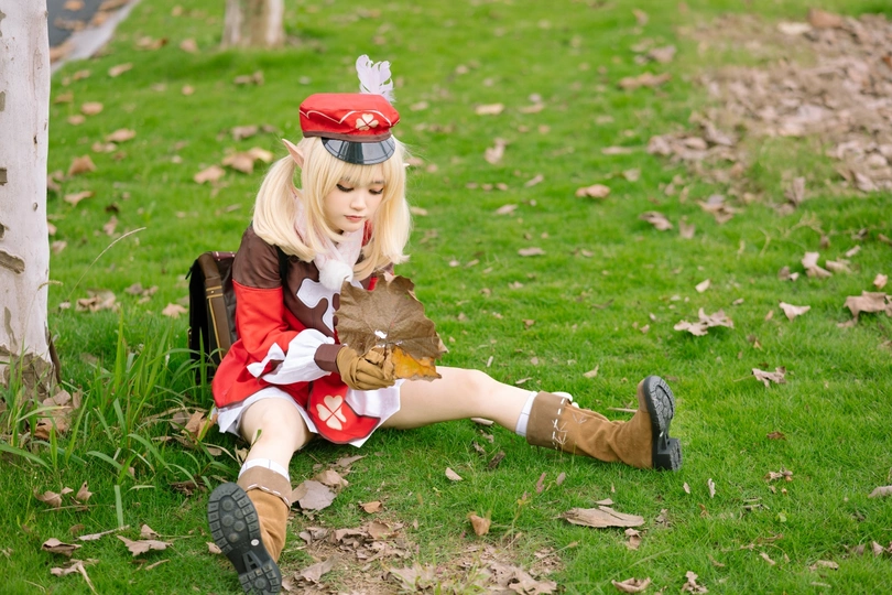 穿着服装的女孩坐在草地上