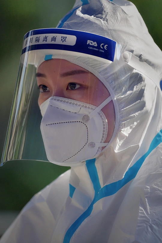 穿着塑料防护服、口罩和护目镜的人