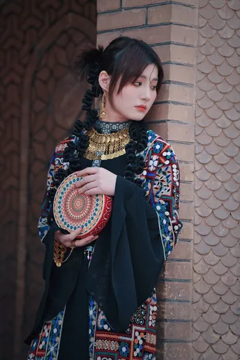 一位穿着传统服装的女孩站在一面墙前