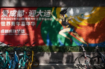 停在有彩色壁画涂鸦的建筑物前的自行车。