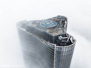 雾中一栋高楼的顶部照片