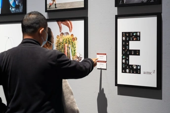 一个男人正在看墙上的照片