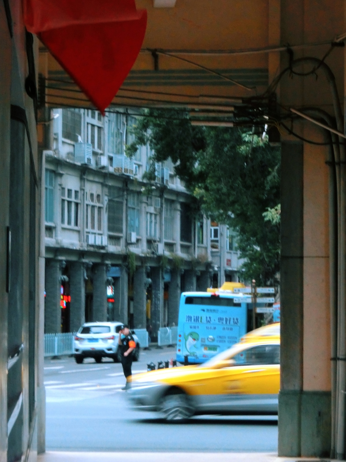 黄色出租车在城市街道上行驶 周围有建筑物。