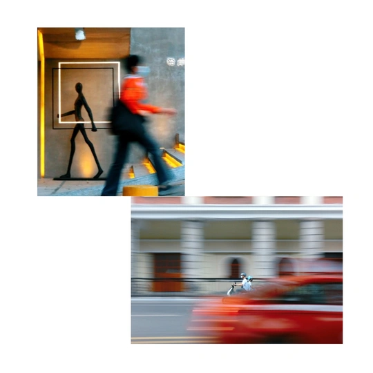 模糊的照片 一座有红门的建筑 一个人在它前面跑过 街上的一个模糊的红车图像。