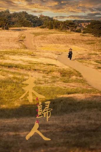一个骑摩托车穿越田野的男子在土路上行驶