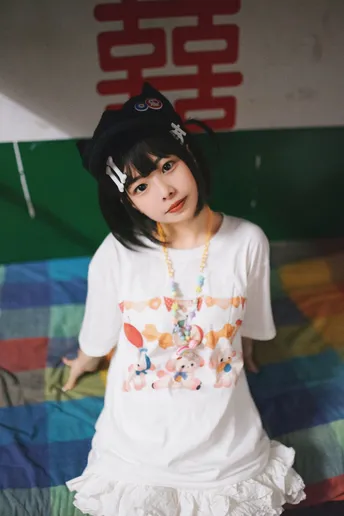 一个小女孩穿着白色衬衫和帽子站在床上