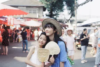 一对年轻女性戴着帽子走下街道