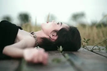 一个男子和一个女人躺在木制的田野上。