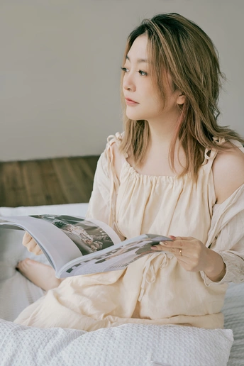 一个年轻女子坐在床上读书