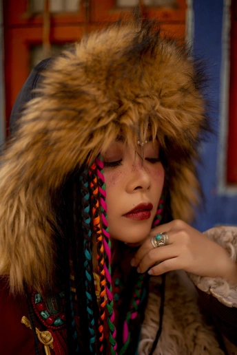 一位戴帽子、外套、皮草、口红和戒指的女青年
