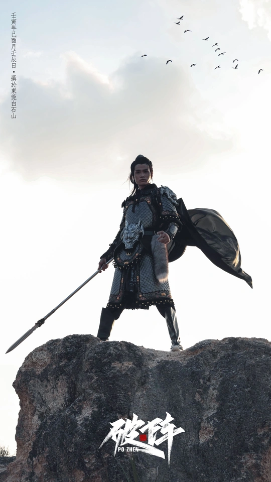 一个人站在岩石上持有一把剑