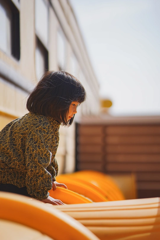 一个年轻女子坐在橙色长凳上