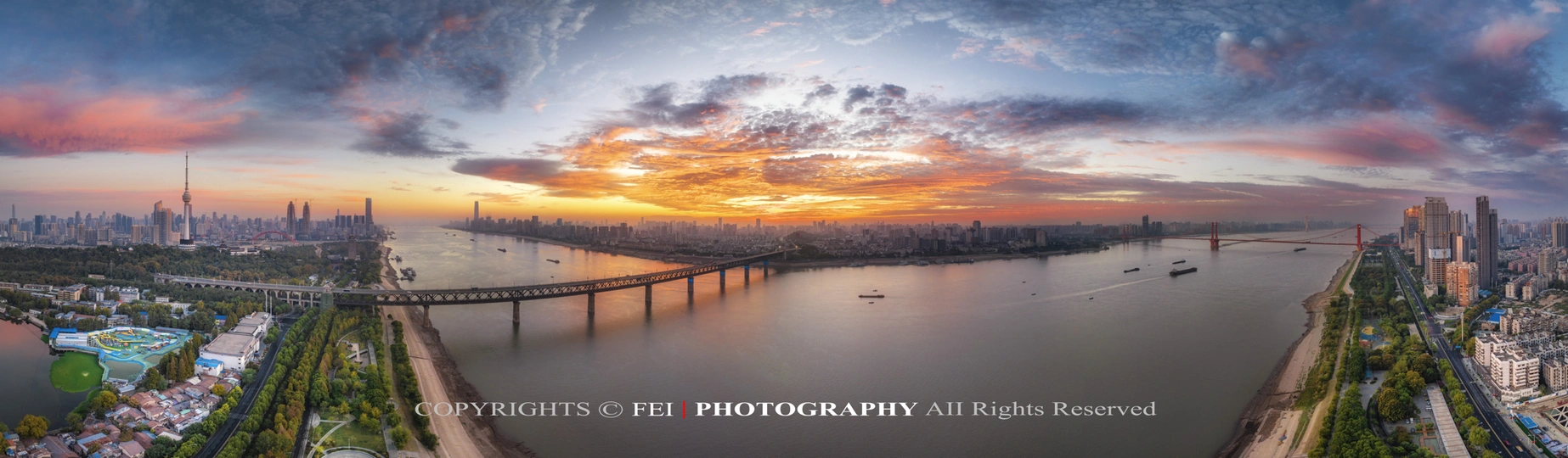 夕阳下跨河的大城市照片