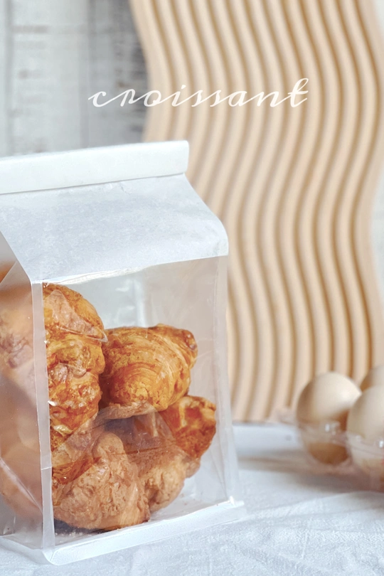 桌子上放着一个装满饼干和一盒鸡蛋的塑料容器