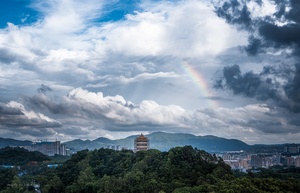 雨过天晴时 城市和山峦上空出现彩虹