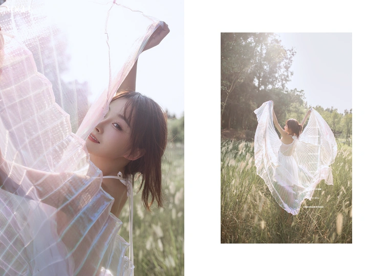 一位年轻女子穿着白色长裙和头纱站在田野中