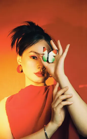 一位戴红帽子的女人 脸上有一个蝴蝶 手指上有手